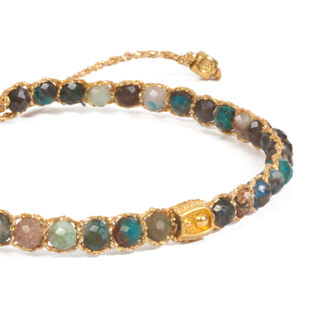 Woven bracelet with colorful gemstone beads, featuring a prominent gold nugget.