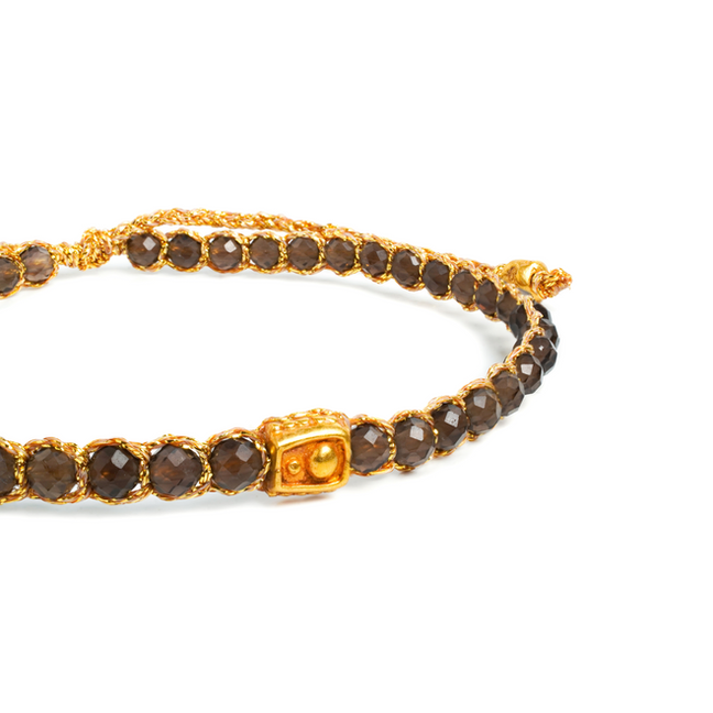 Brown faceted beaded bracelet with golden thread and rectangular clasp.