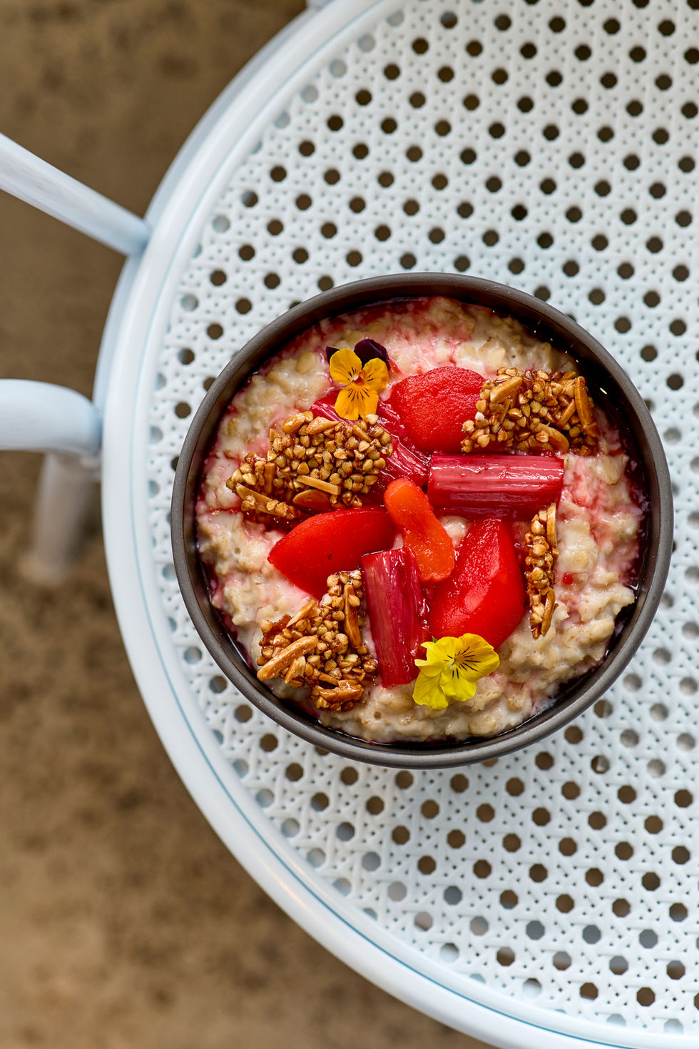 Colorful breakfast bowl with fresh fruit and granola at Kamu Melbourne, showcasing a vibrant and nutritious meal.