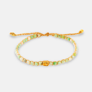 Green beaded bracelet with a gold square bead on a white background.