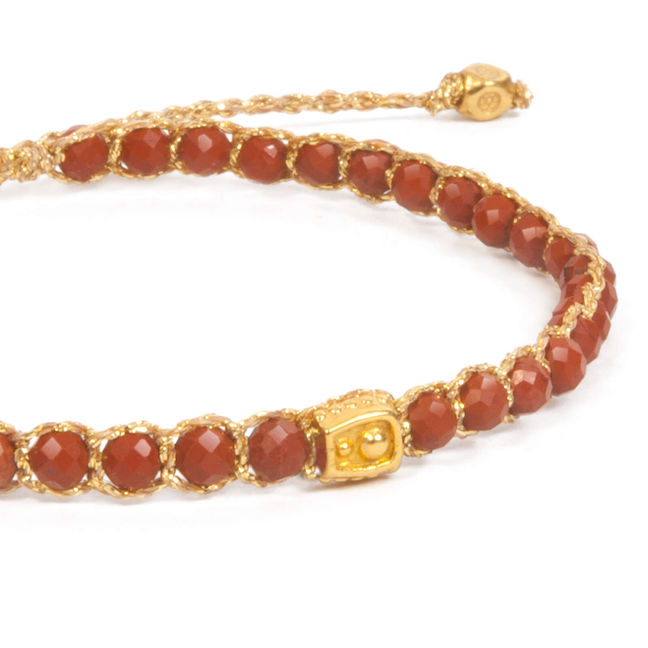 Elegant red beaded bracelet with intricate gold chain and central charm.