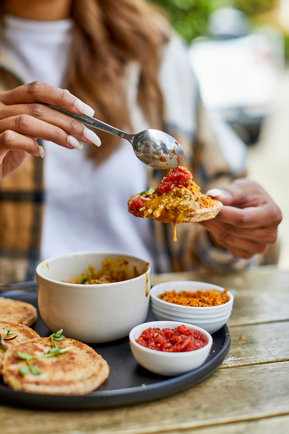 Traditional dish with dipping sauces at Kamu, showcasing rich and diverse culinary offerings.