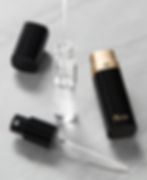Black and gold cosmetic bottles with liquid being poured into a glass vial on a marble surface. "M.Y.O Cosmetic Cases" text visible.