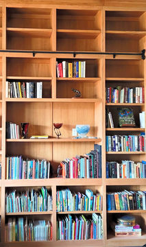 Natural wood office custom built-in bookshelves for easy storage and access