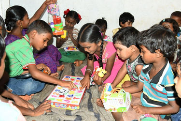 Children playing with toys and a puzzle, group of kids, NGO, Punorutthan.