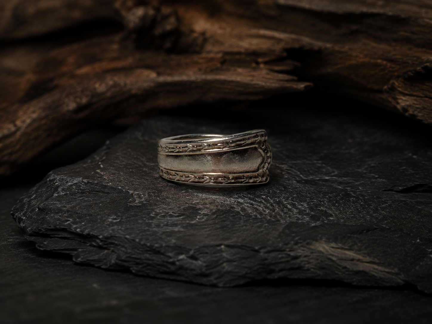 Silver Ring 9 on a dark slate rock with wood background