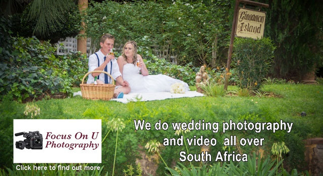 A wedding couple sitting on green grass in a beautiful garden drinking champagne and enjoying the moment