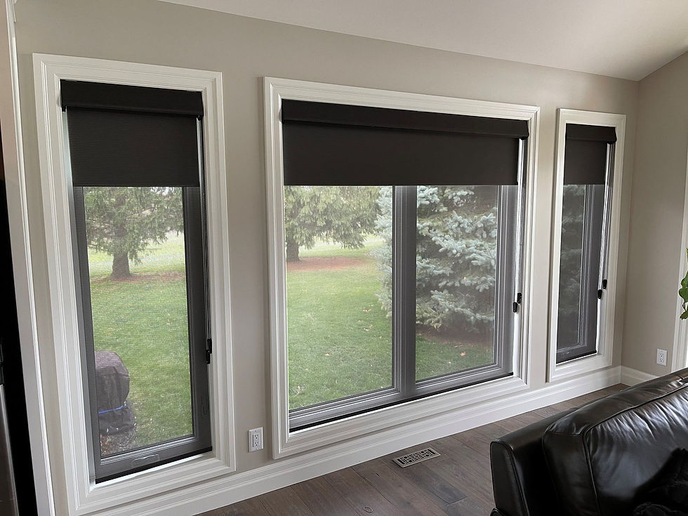 Side view of large window units covered by black textured roller shades that are inside-mounted