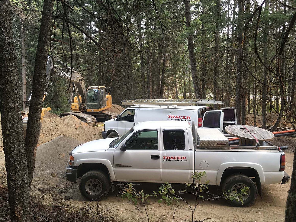 tracer electric inc. trucks at construction site