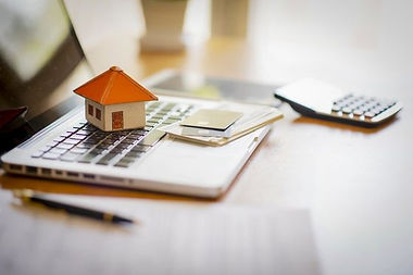 house replica lying on a laptop