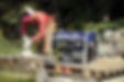 man using a cutter powered by a generator