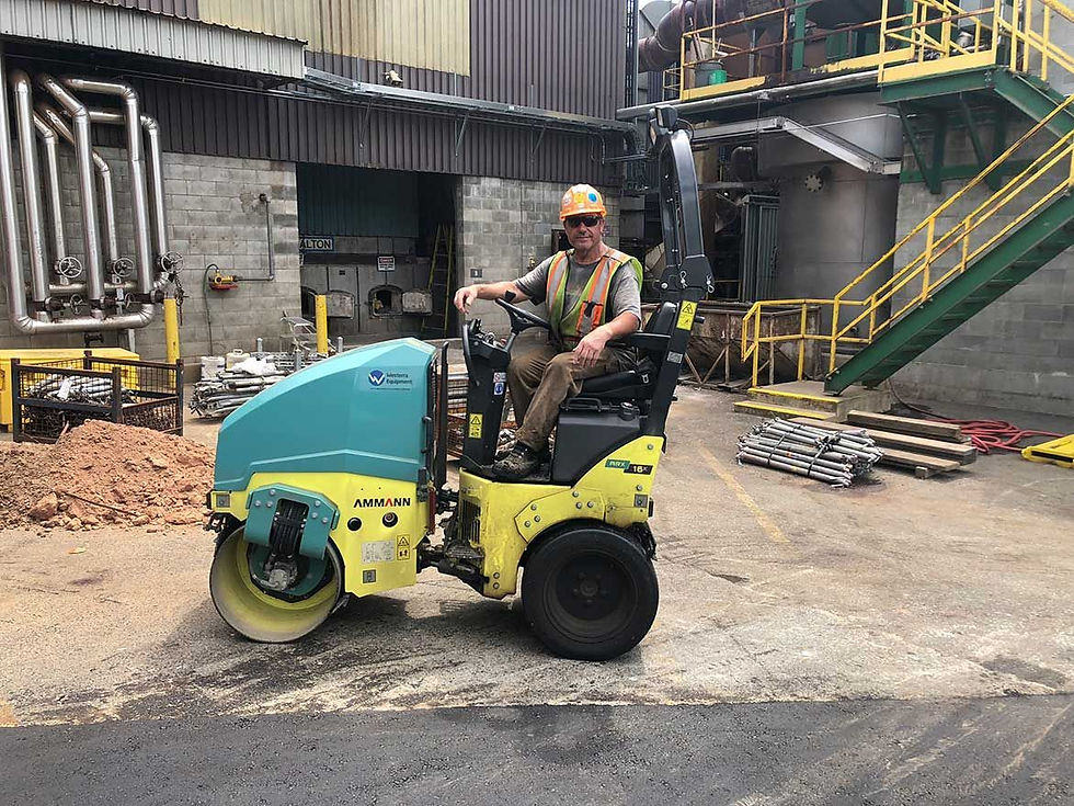 man sitting on a mini road roller