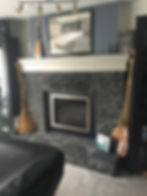 Black fireplace below a painting