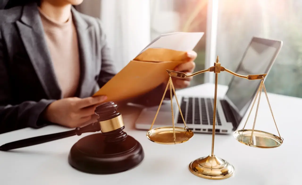 family lawyer in front of the laptop with the justice scale and gavel