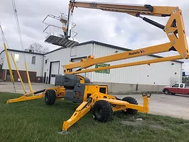 A yellow coloured lift parked in the open