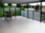 Deck with glass railings and modern furniture