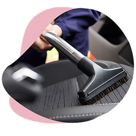 Man cleaning the car seat with a vacuum cleaner