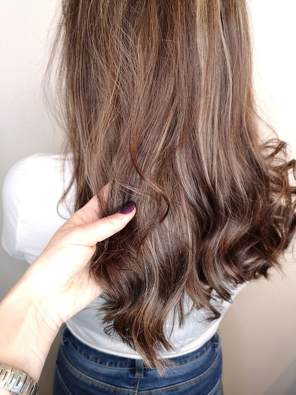 woman feeling her styled hair