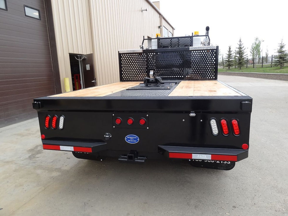 Rear view of flat bed truck with picker deck