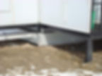 A closeup to the bottom of a metal building