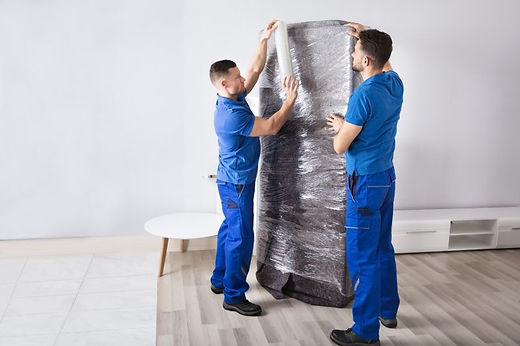 team wrapping a mattress
