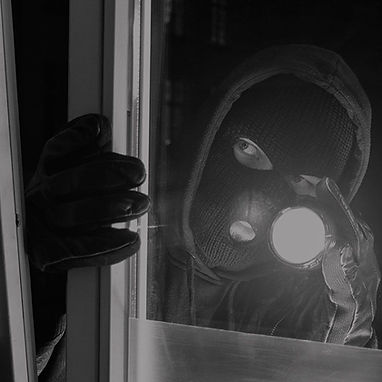 A burglar trying to get inside a property