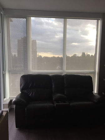 full closed white shades behind couch