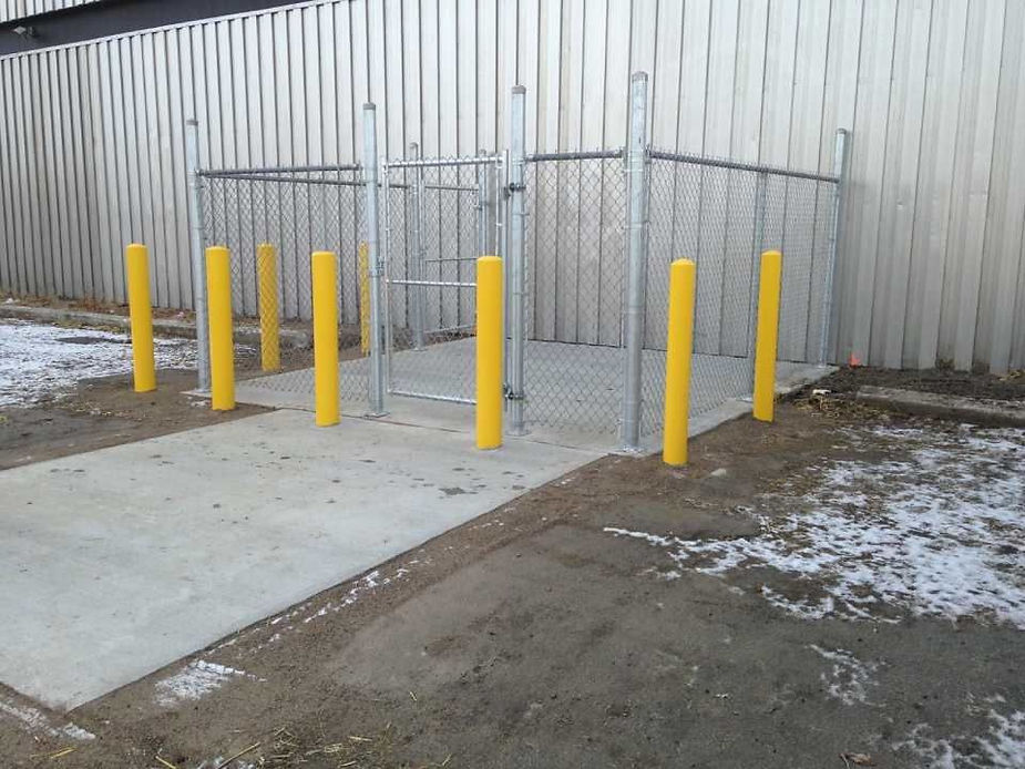 view of installed yellow pillars around fence