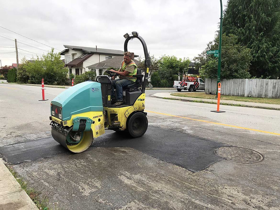 man using a mini road roller