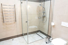 White bathroom interior with glass shower