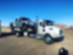 white truck towing car