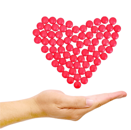 The heart made of red medicine tablets with hand under it