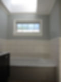view of installed bath tub with tiles on the wall
