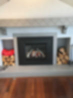 A fireplace and some wooden logs on either side