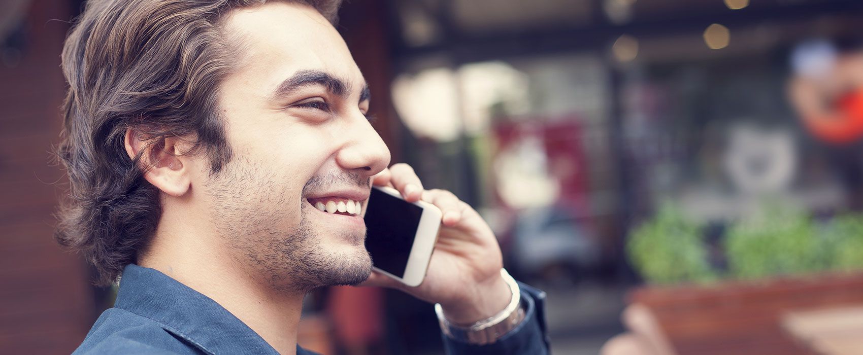 smiling young man talking on mobile phone