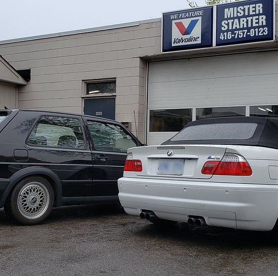 A BMW and a parked car