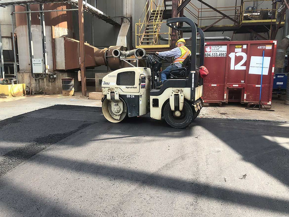 man using mini road roller during asphalt repair