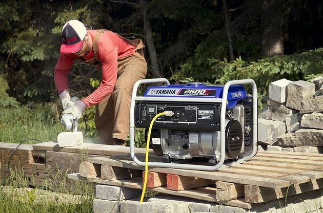 man using a cutter powered by a generator