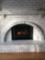 A fireplace built in a grey stone wall