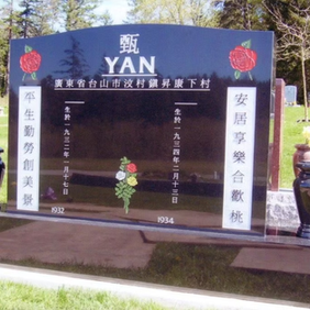 Black Yan Upright Monuments, with Chinese characters, red roses and black vases in the graveyard.