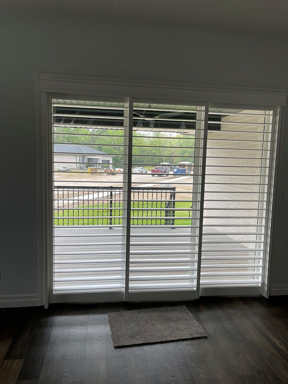 Front view of a sliding glass door unit using shutters that are open