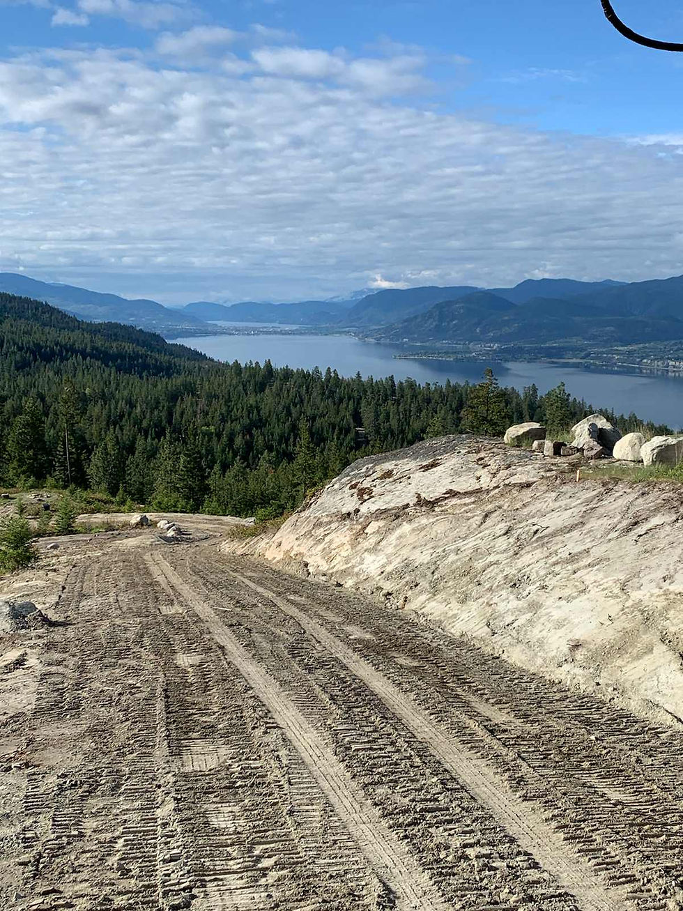 Smoothed hilly surface after excavation with mountains in the background