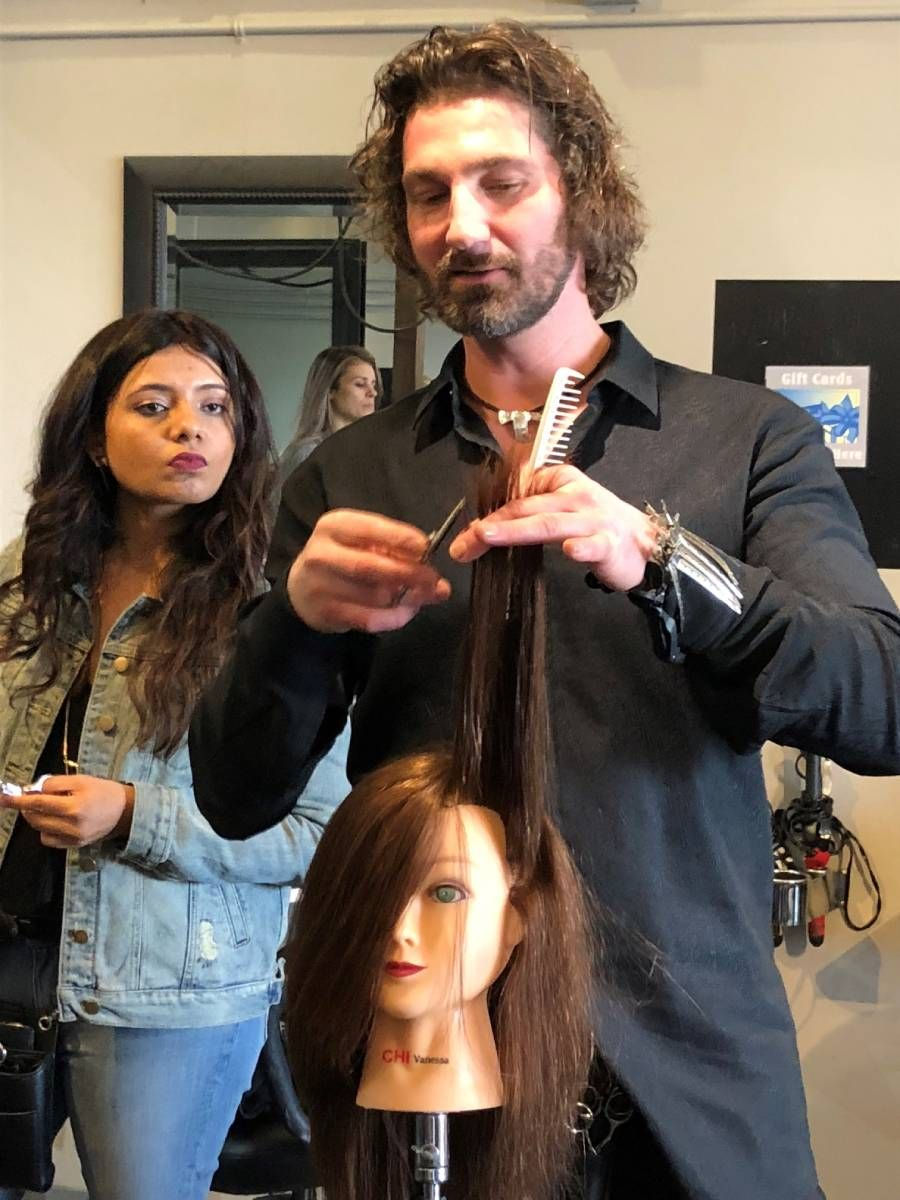 man demonstrating hair cutting