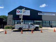 Worker on a crane truck outside a Canadian Blood Services