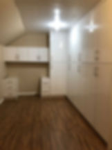 A closet space with tall and short cabinets