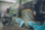 paint technician spraying car