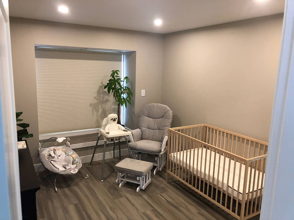 Image showing a children’s room with a wooden bed, a soft chair and white window curtains behind them.