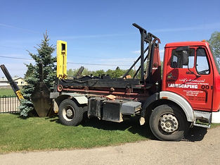 Red landscaping truck with the company logo on the door