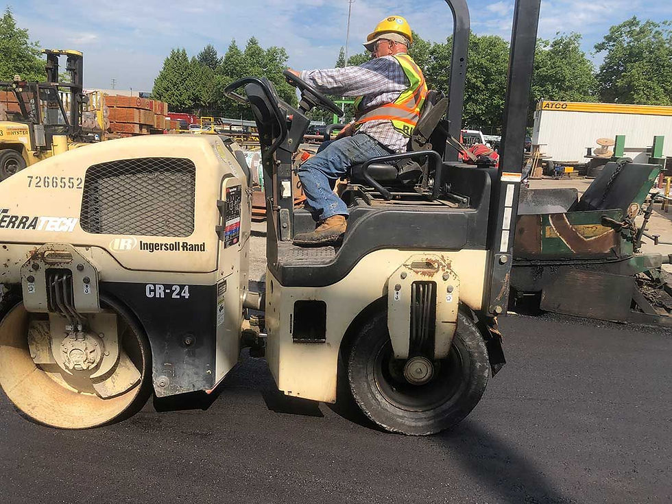 mini road roller being used on a new asphalt road