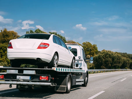 Car secured on a flatbed tow truck after a breakdown or collision